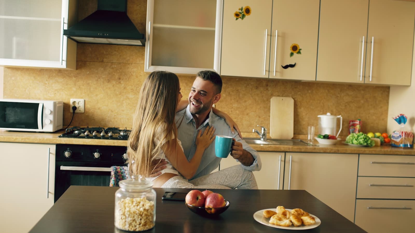 Mature couple enjoying coffee together in a bright kitchen