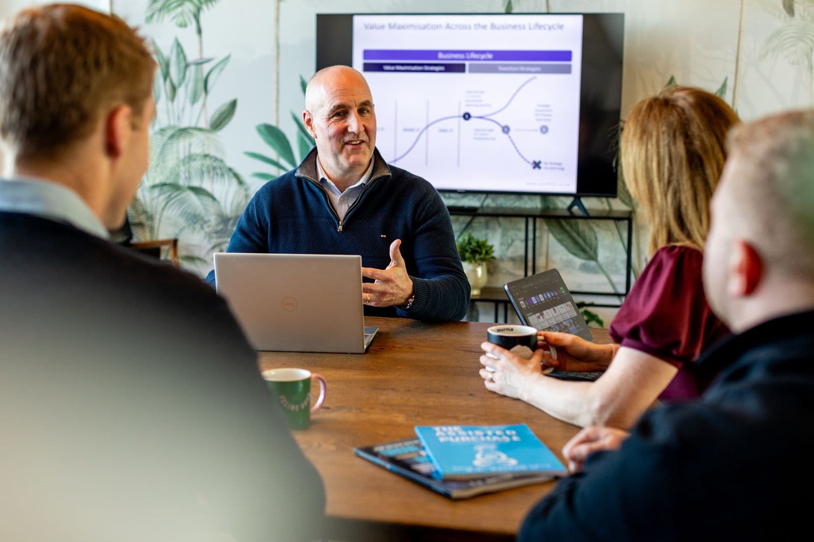 B.D. Dalton presenting to clients at a boardroom table